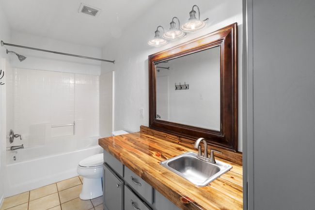 Full bath with vanity, bathing tub / shower combination, and tile patterned floors | Image 23