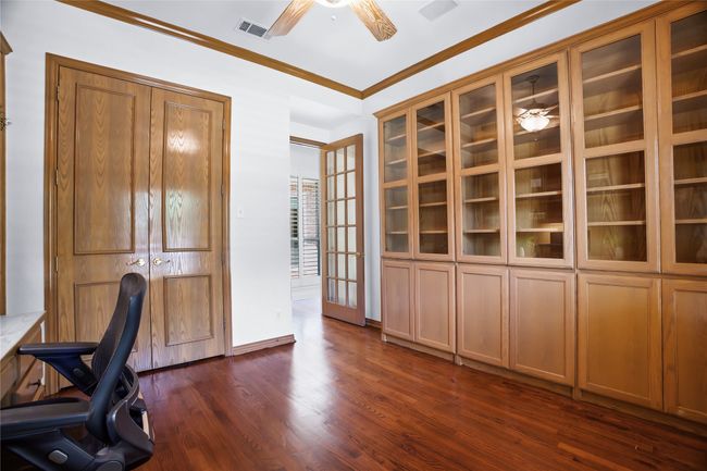 Unfurnished office with a ceiling fan, dark wood finished floors, and ornamental molding | Image 20