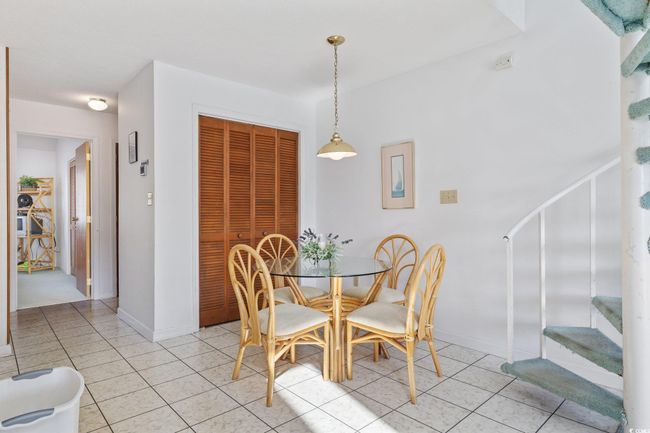 Dining room with stairway, light tile patterned floors, and baseboards | Image 12