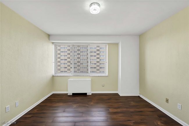 Spare room featuring baseboards and wood finished floors | Image 19