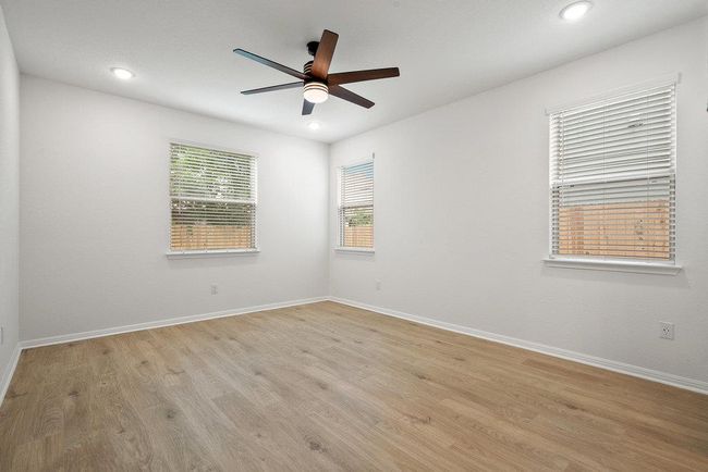 Spare room with a ceiling fan, light wood-type flooring, and recessed lighting | Image 17