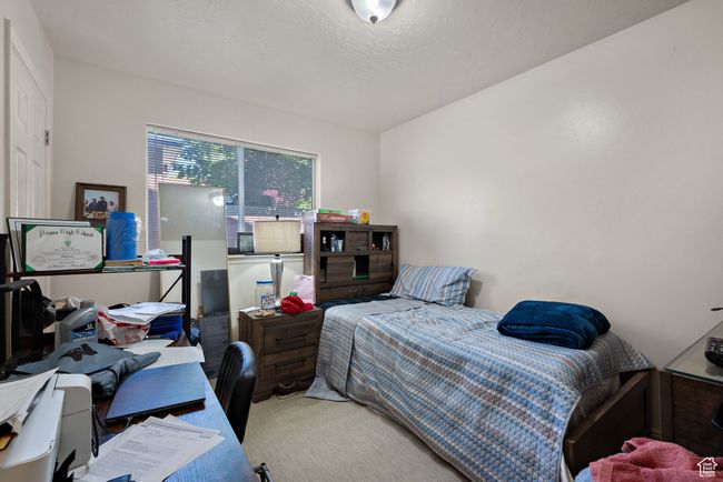 Carpeted bedroom featuring a desk | Image 51