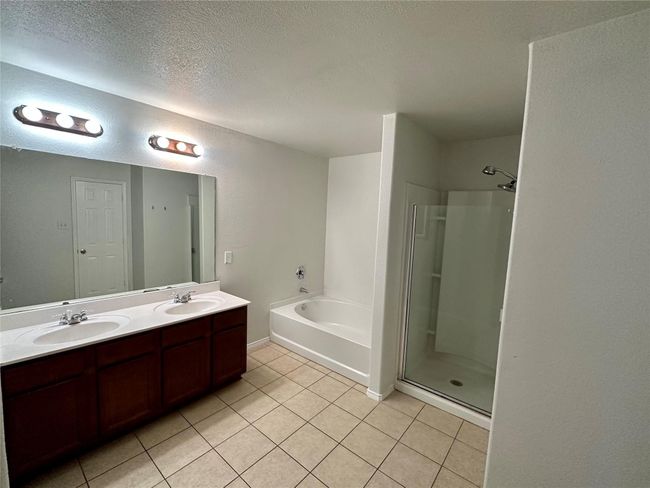 Bathroom with a garden tub, a sink, tile patterned floors, and a stall shower | Image 13