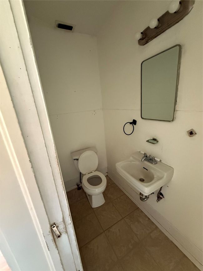 Half bath featuring toilet and tile patterned flooring | Image 9