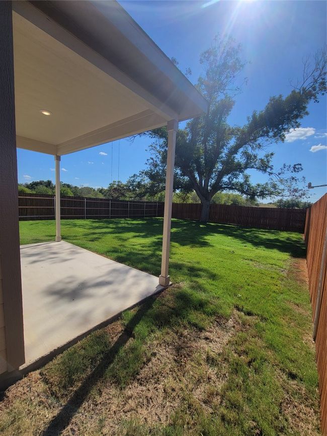 View of yard with a fenced backyard and a patio area | Image 28