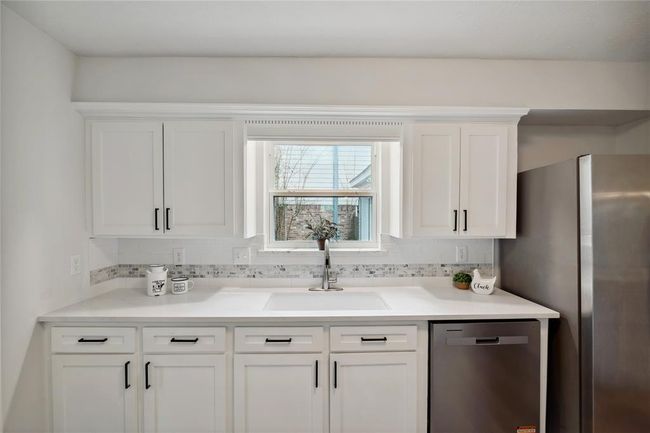 The well planned kitchen has lots of counter-space and this gratifying window looking out to the driveway. | Image 17