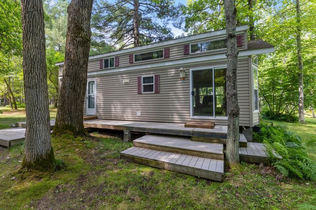Front deck of the guest cabin: 2006 Dutch Park Model. Seller obtained a license with the county which classifies it as a permanent building (doesn't need to be moved). | Image 24