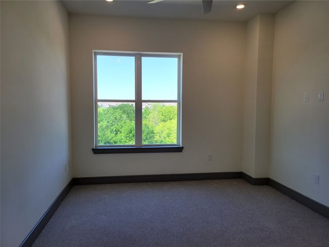 Carpeted empty room with a ceiling fan, recessed lighting, and baseboards | Image 13
