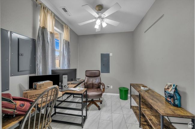 Living area featuring electric panel, marble finish floor, ceiling fan, and visible vents | Image 27