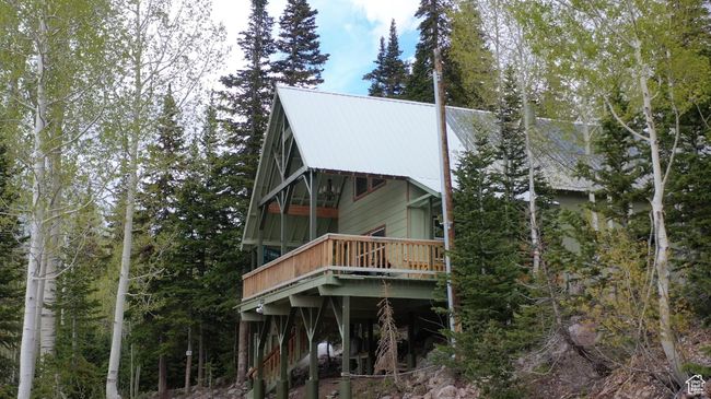 Rear view of property featuring a deck and a metal roof | Image 52