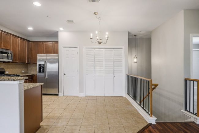 Kitchen featuring stainless steel appliances, tile flooring decorative backsplash, and granite countertops | Image 8
