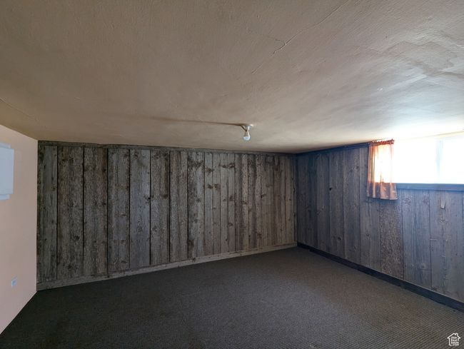 Below grade area with carpet floors and wooden walls | Image 16