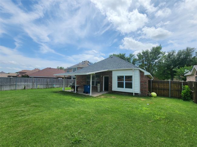 Rear view of property featuring brick siding, a patio, and roof with shingles | Image 24