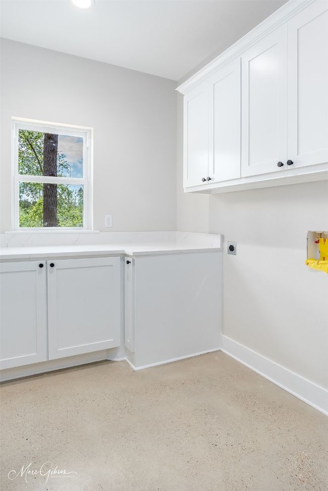Laundry room with baseboards, hookup for an electric dryer, and cabinet space | Image 19