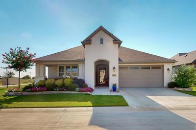 View of front facade with a front yard and a garage | Image 2