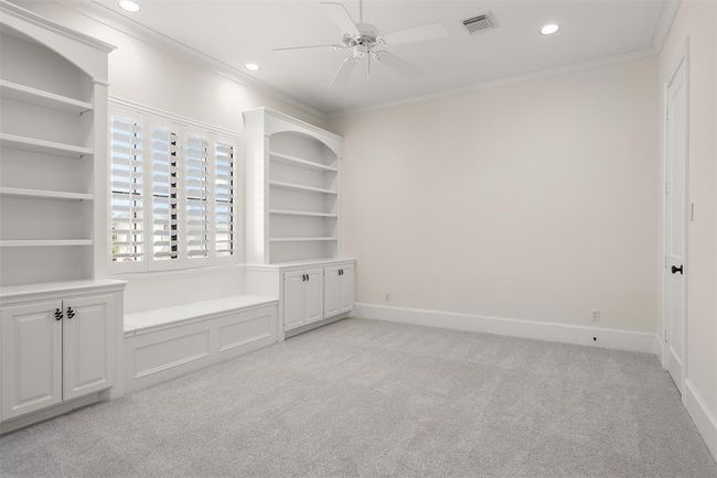 Bedroom #2 offers high ceilings, built in bookshelves, bench and cabinets, shutters and recessed lighting. | Image 39