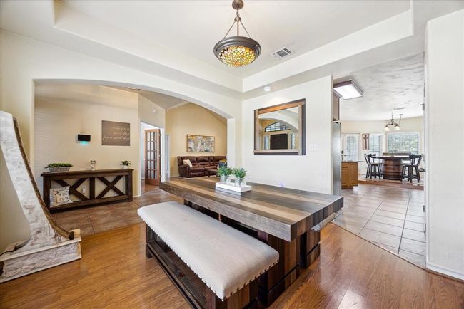 Notice the custom arched entrance, the trey ceiling and the custom nook for the buffet/china hutch. | Image 10