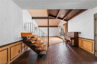 Stairs with a textured ceiling and vaulted ceiling | Image 3