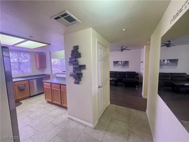 Kitchen featuring dishwasher, a textured ceiling, visible vents, and ceiling fan | Image 5