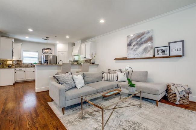Living area featuring dark wood-style floors, recessed lighting, and crown molding | Image 8