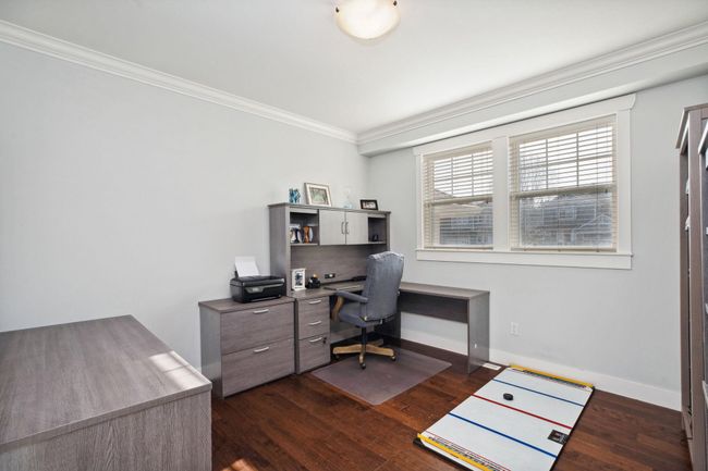 Office featuring dark wood-type flooring, baseboards, and crown molding | Image 28