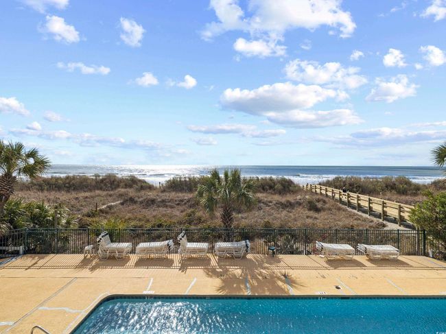 Pool featuring a patio area, a water view, and fence | Image 29