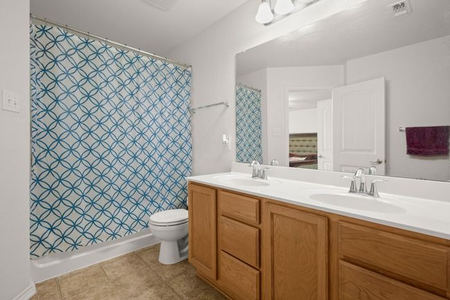 Bathroom with double vanity and toilet | Image 16