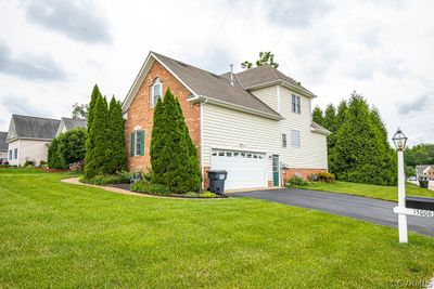 View of home's exterior featuring a garage and a yard | Image 3