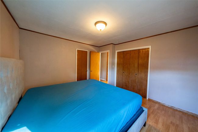 Bedroom featuring ornamental molding, light wood-style floors, a closet, and baseboards | Image 17