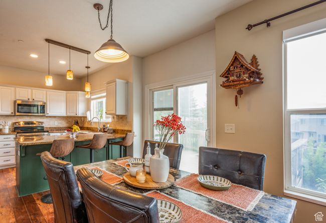 Dining room featuring dark wood finished floors, recessed lighting, and healthy amount of natural light | Image 10