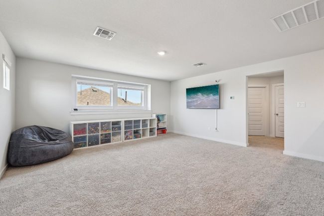 Upstairs, discover the possibilities of this spacious loft – a media lounge, playroom, or cozy retreat. | Image 9