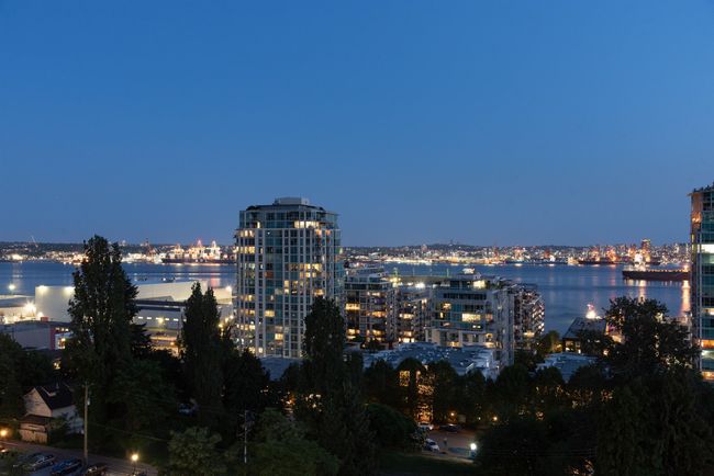 View of city with a view of city lights and a large body of water | Image 15