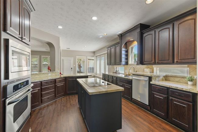 Updated granite, cooktop and dishwasher. There is a gas line in the island if you want gas. | Image 16