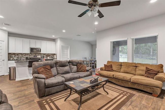 Kitchen and spacious dining are open to living area | Image 24
