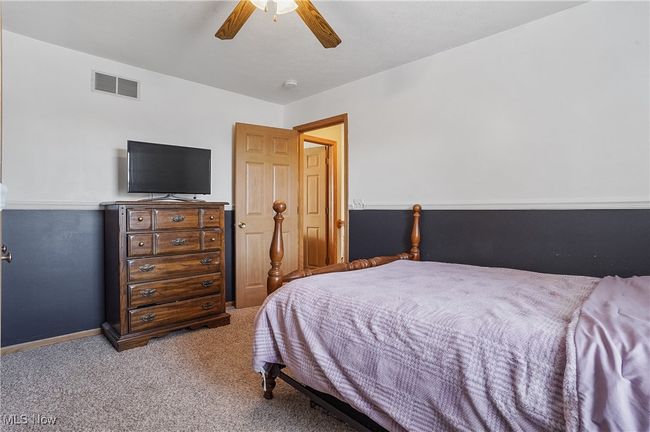 Bedroom featuring visible vents, a ceiling fan, carpet flooring, and baseboards | Image 36