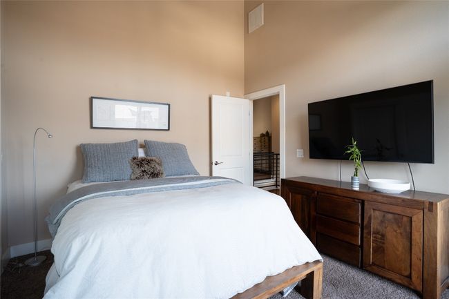 Second bedroom featuring a high ceiling | Image 19
