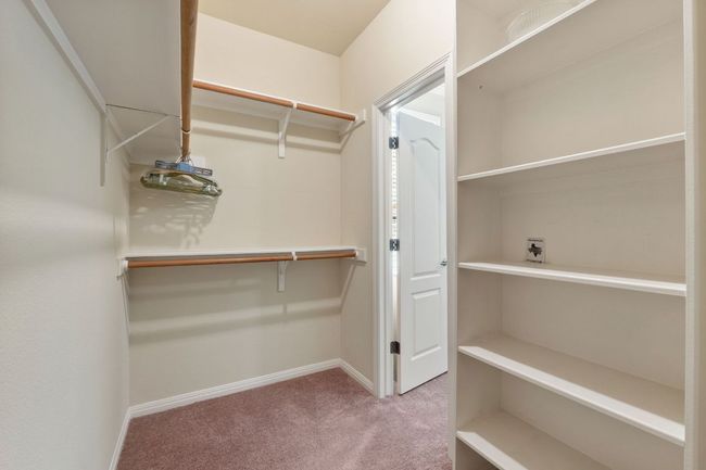 Walk in closet with carpet floors | Image 28