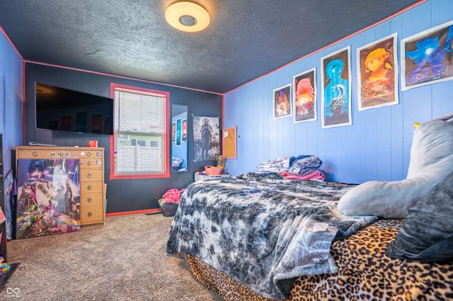 bedroom featuring carpet floors, ornamental molding, a textured ceiling, and baseboards | Image 20