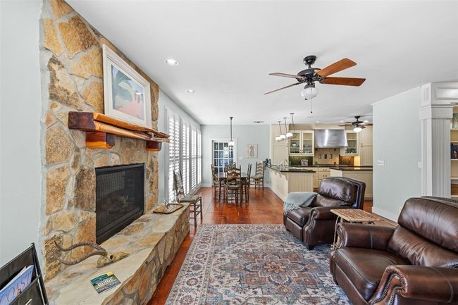 Curl up in front of the fireplace in this cozy den area to enjoy a good book and morning coffee. | Image 14