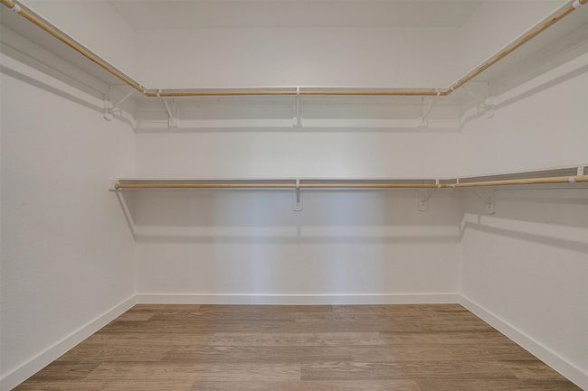 Walk in closet with wood finished floors | Image 22