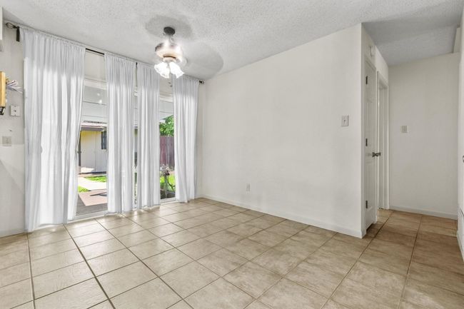 There's plenty of room for a full-size dining table, with natural light creating a comfortable, welcoming atmosphere. | Image 16