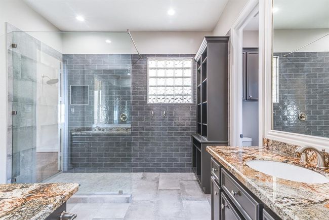 Another view of the spectacular shower plus built in storage cabinetry and dual vanities. | Image 11