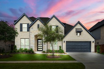 Welcome home to 7314 Autumn Sage! This stunning 2 story home welcomes you with sensational curb appeal, lush landscaping, and a well-maintained yard. It features an elegant exterior with cream brick and stone, contrasting dark trim, and a spacious 3 car garage! | Image 1