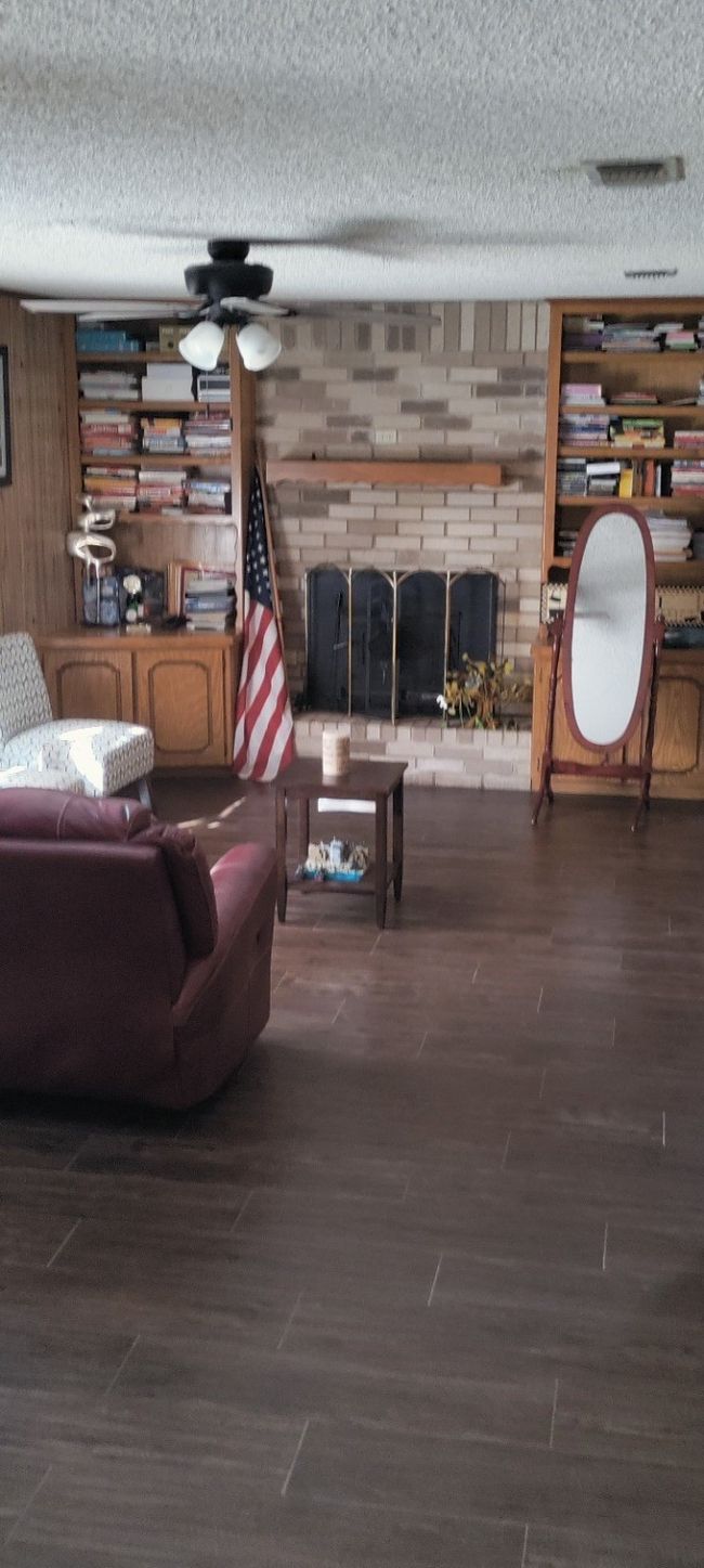 Living area with a textured ceiling and wood finished floors | Image 17