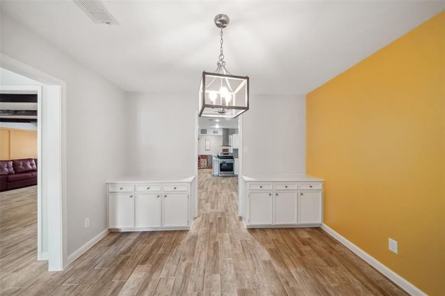 VIEW FROM THE DINING ROOM TO THE SPACIOUS KITCHEN AND SUPER LARGE FAMILY ROOM PERFECT FOR ENTERTAINING | Image 11