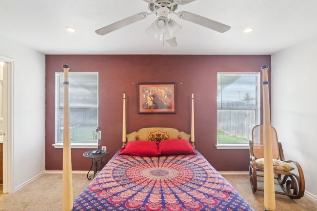 Carpeted bedroom featuring baseboards, multiple windows, recessed lighting, and ceiling fan | Image 10
