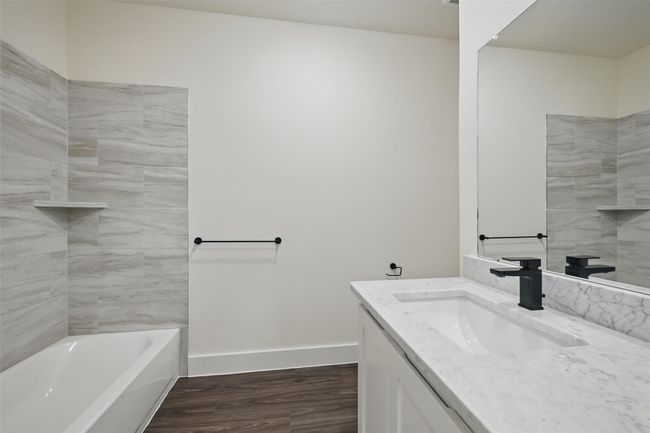 Full bathroom featuring baseboards, wood finished floors, and vanity | Image 14