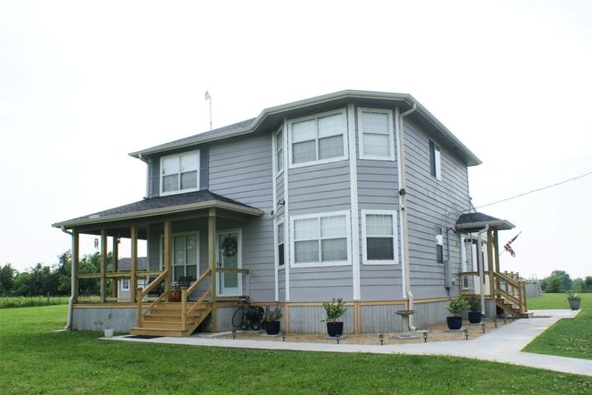 View of front facade with a front lawn and a porch | Image 8