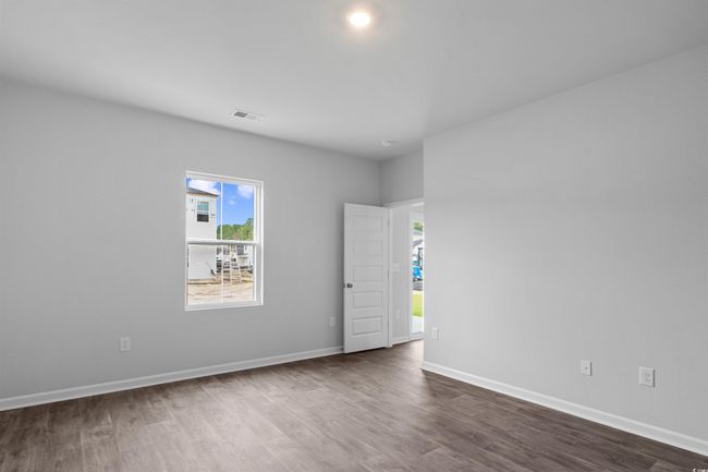 Empty room featuring baseboards and dark wood finished floors | Image 5