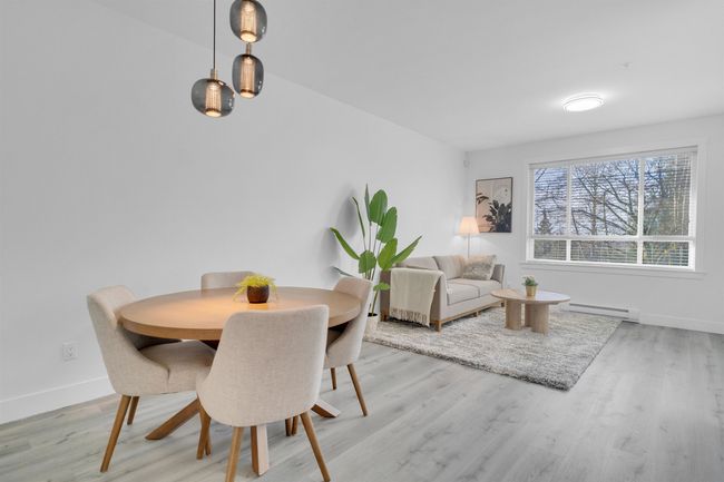 Dining space with light wood-style floors, baseboards, and baseboard heating | Image 10